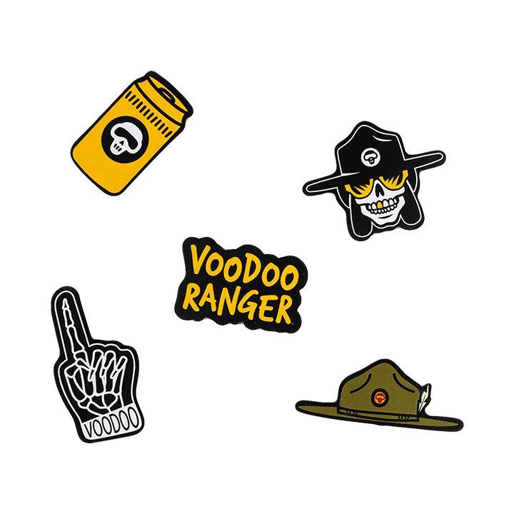 The five Voodoo Ranger Jibbitz: a yellow beer can, the Voodoo Ranger character head, a skeleton foam finger, the Voodoo Ranger wide-brimmed hat, and the Voodoo Ranger logo.