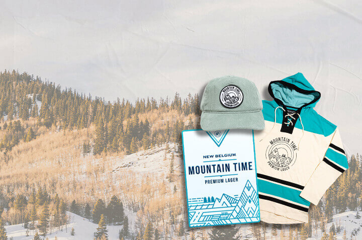 Mountain Time hockey sweatshirt, hat, and metal bar tacker on a snowy mountain background. 
