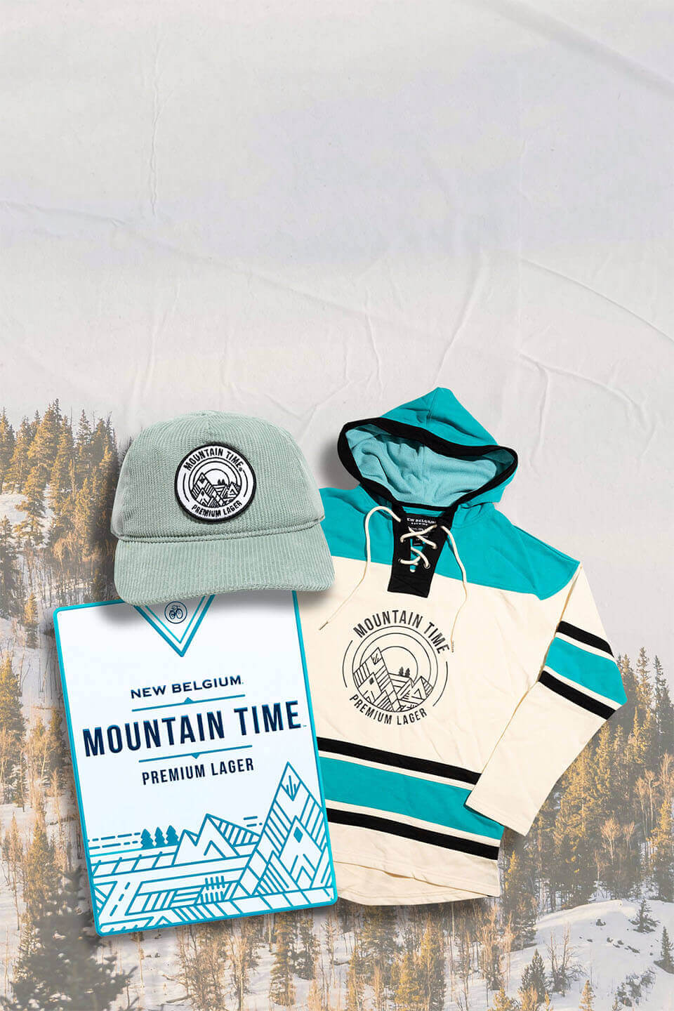 Mountain Time hat, hockey sweatshirt, and metal bar tacker on a snowy mountain background. 