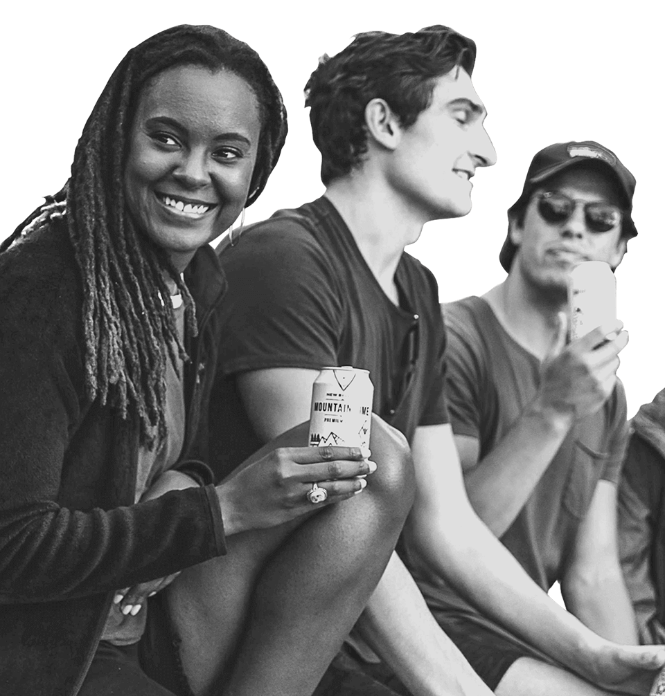 Four people outdoors enjoying Mountain Time Lager together. 